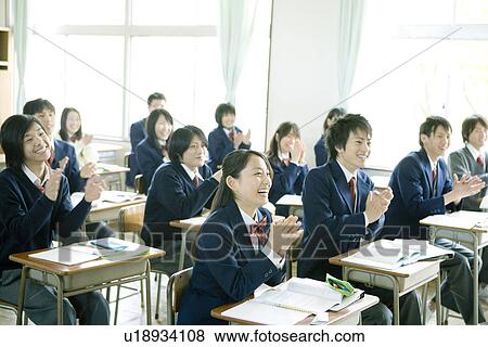 Stock Photo - High school students in classroom, smiling and clapping hands. Fotosearch