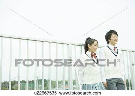 High school students leaning on the railing, smiling View Large Photo Image Stock Photography - High school students leaning on the railing, smiling. Fotosearch