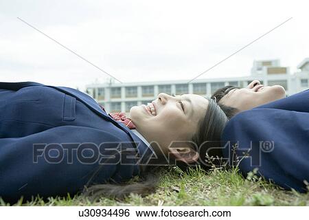 High school students lying on lawn, smiling, close up View Large Photo Image Stock Photograph - High school students lying on lawn, smiling, close up. Fotosearch
