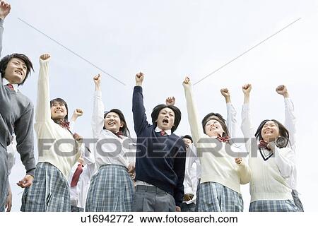 Stock Image - High school students punching the air, white background. Fotosearch