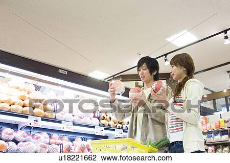 Couple shopping at supermarket View Large Photo Image Stock Image - Couple shopping at supermarket. Fotosearch