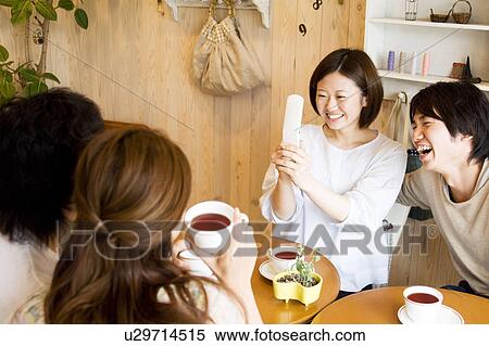 Group of young people at a café View Large Photo Image Stock Photography - Group of young people at a café. Fotosearch