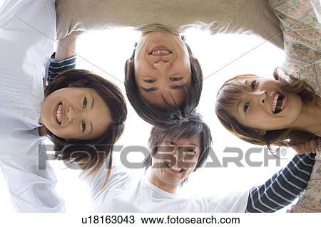 Group of young people in a huddle View Large Photo Image Stock Image - Group of young people in a huddle. Fotosearch