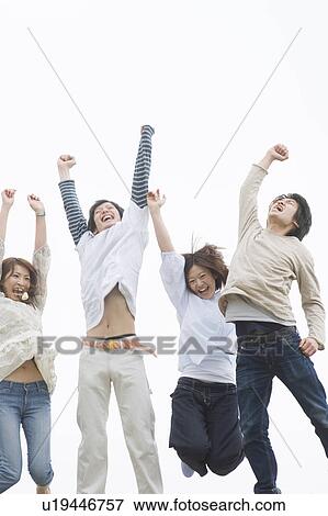Stock Photo - Group of young people jumping in air. Fotosearch