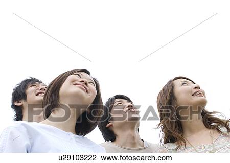 Stock Image - Group of young people looking up. Fotosearch