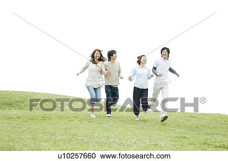 Group of young people running on grass View Large Photo Image Stock Image - Group of young people running on grass. Fotosearch