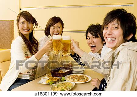 Stock Photo - Group of young people toasting beer. Fotosearch