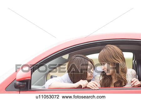 Stock Image - Two young women in a car. Fotosearch