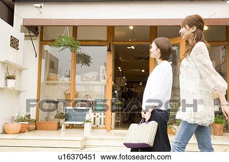 Two young women shopping View Large Photo Image Stock Image - Two young women shopping. Fotosearch