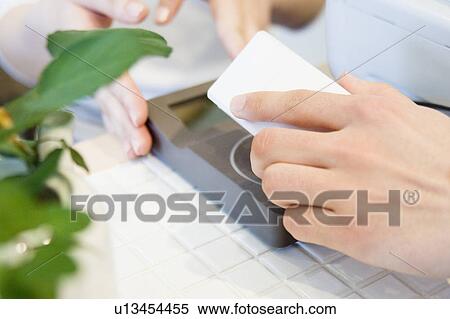 Using mobile phone for payment View Large Photo Image Stock Photography - Using mobile phone for payment. Fotosearch