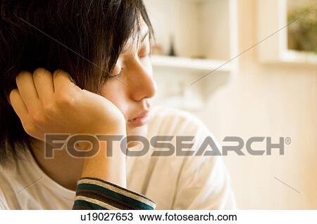Stock Image - Young man with closed eyes. Fotosearch