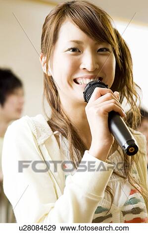 Young women singing karaoke View Large Photo Image Stock Photo - Young women singing karaoke. Fotosearch