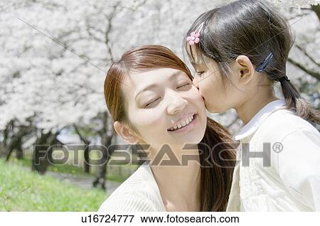 A Girl Kissing Mother's Cheek View Large Photo Image Stock Photo - A Girl Kissing Mother's Cheek. Fotosearch
