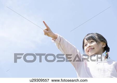 A Girl Pointing the Sky View Large Photo Image Stock Photo - A Girl Pointing the Sky. Fotosearch