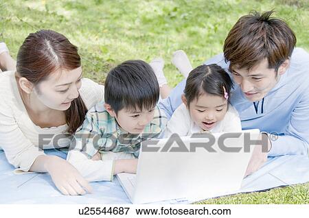 Stock Photo - Family Looking at PC. Fotosearch