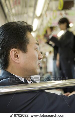 Stock Image - Businessman on the train, close up, differential focus. Fotosearch