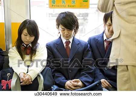 Stock Photo - High school students on the train, sleeping on the seat. Fotosearch