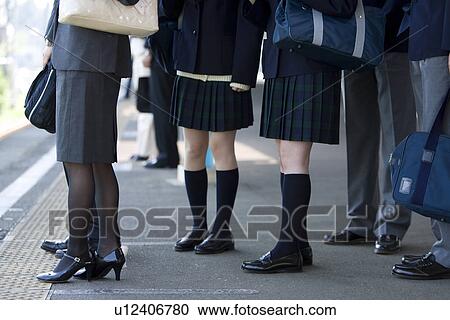 Stock Image - People waiting for the train at platform. Fotosearch