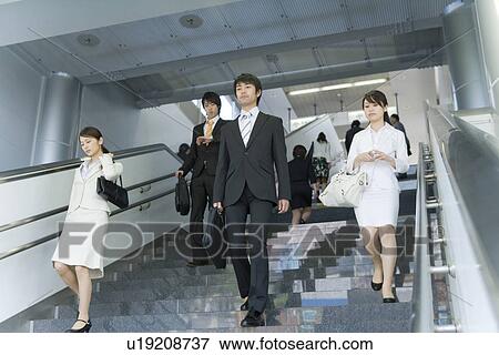 People walking down the stairs at station View Large Photo Image Stock Photo - People walking down the stairs at station. Fotosearch