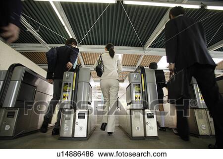 People walking through automatic ticket wicket at station, blurred motion View Large Photo Image Stock Photograph - People walking through automatic ticket wicket at station, blurred motion. Fotosearch