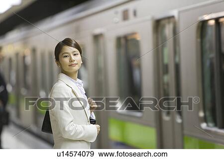 Stock Photo - Portrait of a woman at platform, smiling. Fotosearch