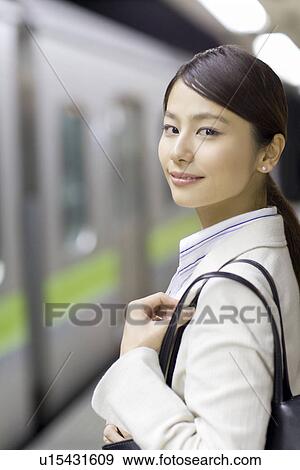 Stock Photo - Portrait of a woman at platform, smiling. Fotosearch