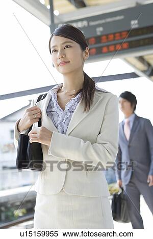 Young woman at platform, smiling View Large Photo Image Stock Photography - Young woman at platform, smiling. Fotosearch