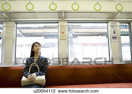 Young woman on the train, sitting on the seat View Large Photo Image Stock Image - Young woman on the train, sitting on the seat. Fotosearch