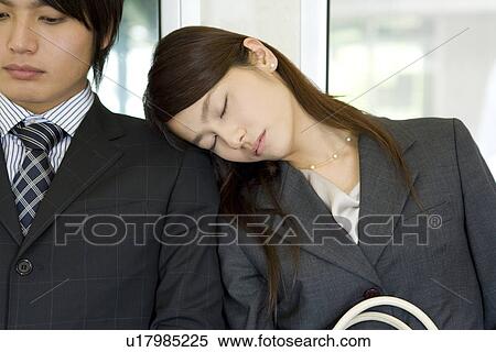 Young woman sleeping on the seat, leaning on man's shoulder View Large Photo Image Stock Photography - Young woman sleeping on the seat, leaning on man's shoulder. Fotosearch