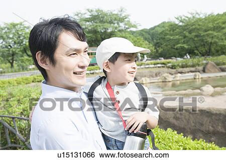 Stock Photograph - Father Holding His Son in Zoo. Fotosearch