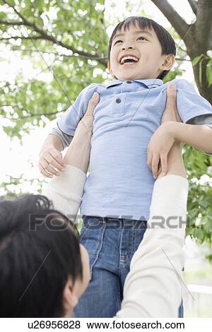 Stock Photo - Father Holding Up His Son. Fotosearch