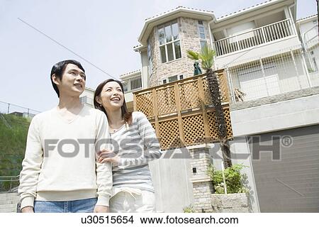 Picture - Mid Adult Couple Looking Up the Sky. Fotosearch