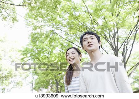 Mid Adult Couple Walking in Park View Large Photo Image Stock Photo - Mid Adult Couple Walking in Park. Fotosearch
