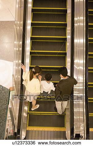 Son and Two Parent Ridding on Escalator in Department Store View Large Photo Image Stock Photograph - Son and Two Parent Ridding on Escalator in Department Store. Fotosearch