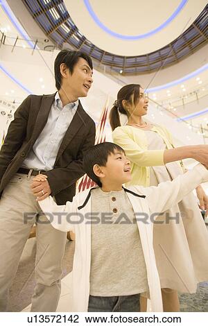 Son and Two Parent Shopping in Department Store View Large Photo Image Stock Image - Son and Two Parent Shopping in Department Store. Fotosearch