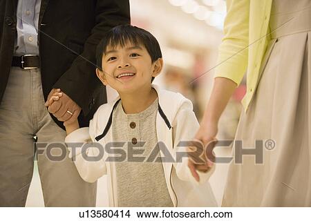 Picture - Two Parents and Son, Holding Hands. Fotosearch