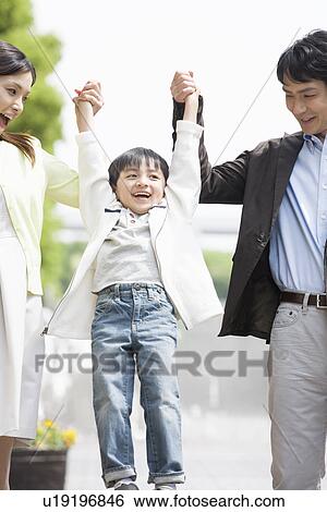 Stock Photograph - Two Parents and Son Holding Hands. Fotosearch