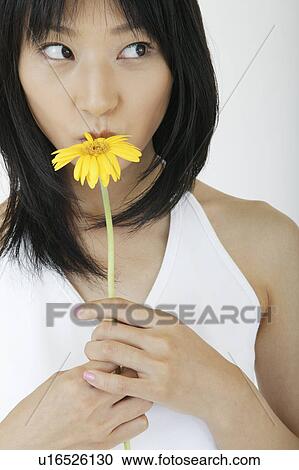 A young woman kissing to a flower View Large Photo Image Stock Image - A young woman kissing to a flower. Fotosearch