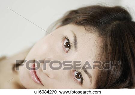Stock Image - A young woman looking at camera. Fotosearch
