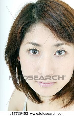 A young woman looking at camera View Large Photo Image Stock Image - A young woman looking at camera. Fotosearch