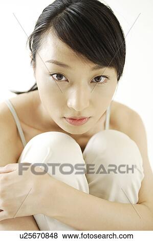 Stock Photo - A young woman looking at camera. Fotosearch
