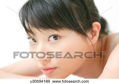 Stock Photo - A young woman looking at camera. Fotosearch