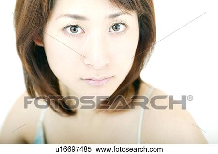Stock Photography - A young woman looking at camera. Fotosearch