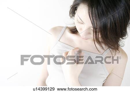 Stock Photo - A young woman looking down. Fotosearch
