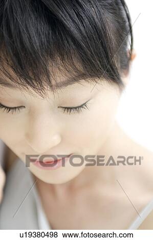 A young woman looking down View Large Photo Image Stock Photo - A young woman looking down. Fotosearch