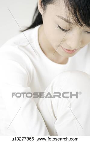 A young woman looking down View Large Photo Image Stock Photograph - A young woman looking down. Fotosearch