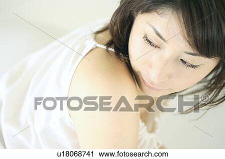 Stock Image - A young woman looking over her shoulder. Fotosearch