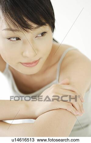 Stock Image - A young woman sitting. Fotosearch