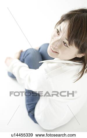 Stock Photo - A young woman sitting. Fotosearch