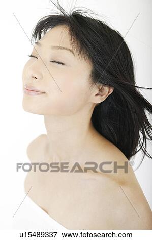 Stock Photo - A young woman smiling. Fotosearch